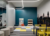 Thumbnail 4 of 28 - a room with a table and chairs and a blue wall with a map on it
