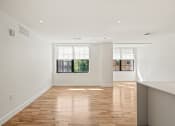 Thumbnail 22 of 33 - a living room with white walls and a window
