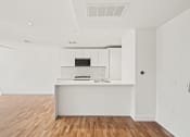 Thumbnail 23 of 33 - living room and kitchen with a large island and hardwood floor