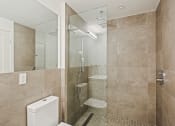 Thumbnail 21 of 33 - a bathroom with a shower and a toilet