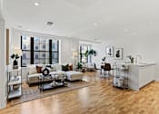 Thumbnail 1 of 33 - A living room with a white sofa set and a wooden floor.