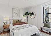Thumbnail 5 of 33 - A bedroom with a large bed and a window overlooking a city.