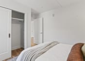 Thumbnail 6 of 33 - A bedroom with a bed and a closet.
