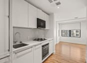 Thumbnail 20 of 33 - A modern kitchen with white cabinets and stainless steel appliances