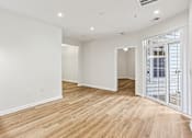 Thumbnail 1 of 33 - a living room with white walls and wood floors