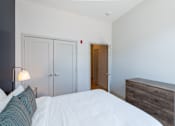 Thumbnail 5 of 6 - a bedroom with a bed and a dresser