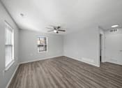 Thumbnail 11 of 17 - A room with a ceiling fan and a window with blinds.