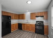 Thumbnail 6 of 17 - A kitchen with black appliances and wooden cabinets.