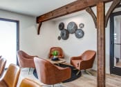 Thumbnail 2 of 16 - a living room with leather chairs and plates on the wall