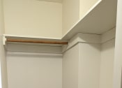 Thumbnail 8 of 21 - a walk in closet with shelves and a wood floor