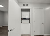 Thumbnail 7 of 17 - A white fridge in a room with a door open.