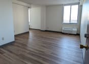 Thumbnail 10 of 21 - an empty living room with wood floors and a window