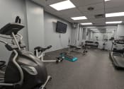 Thumbnail 17 of 21 - a gym with various exercise equipment in a building