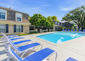 Thumbnail 20 of 25 - A pool surrounded by blue lounge chairs.
