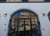 Thumbnail 1 of 21 - a view of the front of a building with a sign in the front door