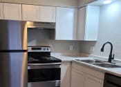 Thumbnail 4 of 16 - a kitchen with stainless steel appliances and white cabinets