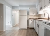 Thumbnail 25 of 39 - a kitchen with white cabinets and a white refrigerator