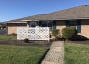 Thumbnail 2 of 21 - a house with a white fence in front of it