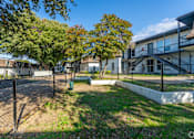 Thumbnail 15 of 19 - A sunny day at a residential area with houses and trees.