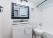 Thumbnail 5 of 6 - a bathroom with a sink and a toilet and a mirror