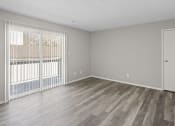 Thumbnail 5 of 25 - an empty living room with wood flooring and a large window