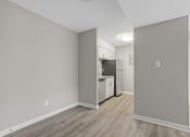 Thumbnail 3 of 25 - the living room and kitchen of an apartment with a refrigerator and stove