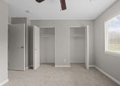 Thumbnail 12 of 25 - an empty bedroom with three closets and a window
