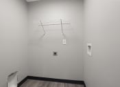 Thumbnail 14 of 25 - a white room with a wire rack on the wall