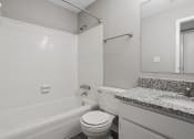 Thumbnail 13 of 25 - a bathroom with a tub and a sink and a toilet