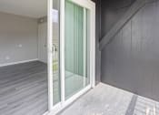 Thumbnail 15 of 25 - a sliding glass door in a room with a staircase