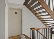 Thumbnail 16 of 25 - a staircase in a home with a white door and a stairwell with a door