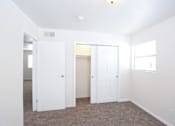 Thumbnail 22 of 27 - A white room with a carpeted floor and a window.