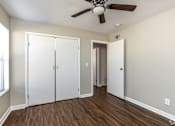 Thumbnail 20 of 27 - A room with a ceiling fan and a white door.