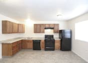 Thumbnail 16 of 27 - A kitchen with black appliances and wooden cabinets.