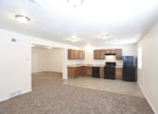 Thumbnail 17 of 27 - A kitchen with black appliances and brown cabinets.