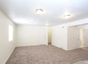 Thumbnail 19 of 27 - A room with carpeted floor and white walls.