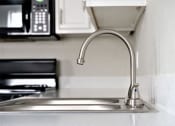 Thumbnail 11 of 27 - a kitchen sink with a faucet and a microwave