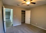 Thumbnail 10 of 14 - carpeted bedroom with large closet and ceiling fan