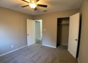 Thumbnail 7 of 14 - carpeted bedroom with large closet and ceiling fan