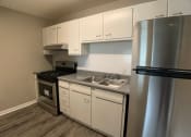 Thumbnail 6 of 14 - kitchen with cabinets and stainless steel appliances