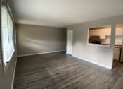 Thumbnail 3 of 14 - large living room with vinyl plank flooring and breakfast bar