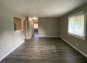 Thumbnail 2 of 14 - large living room with vinyl plank flooring and breakfast bar