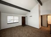 Thumbnail 14 of 26 - the living room of an empty house with carpet and a window