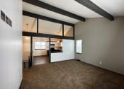 Thumbnail 13 of 26 - the living room and kitchen of an empty house with a carpeted floor