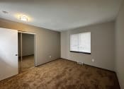 Thumbnail 16 of 26 - an empty room with a window and a closet