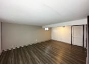 Thumbnail 18 of 26 - an empty living room with wood flooring and sliding glass doors