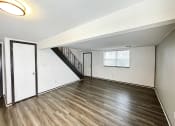 Thumbnail 17 of 26 - the living room and dining room of an empty home with wood flooring