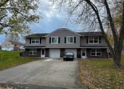Thumbnail 23 of 26 - a large house with a car parked in the driveway