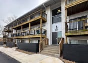 Thumbnail 13 of 15 - the exterior of an apartment building with stairs and a black fence