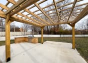 Thumbnail 15 of 15 - a patio with a wooden structure and a fire pit